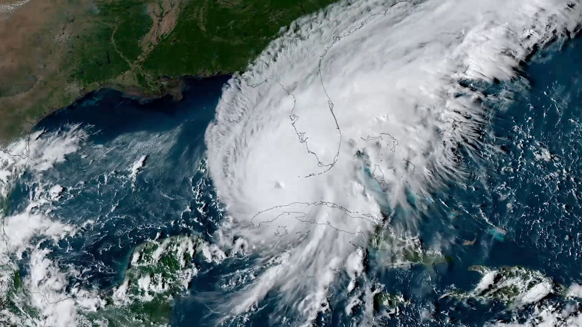 GOES-East satellite view of Hurricane Ian, a large spiral of cloud with a defined eye, approaching the southwest coast of the Florida peninsula on September 27, 2022